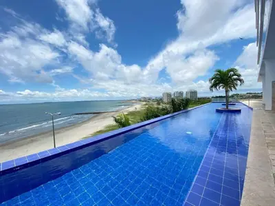 a swimming pool with a view of the beach at Apartamento con vista al mar in Cartagena de Indias