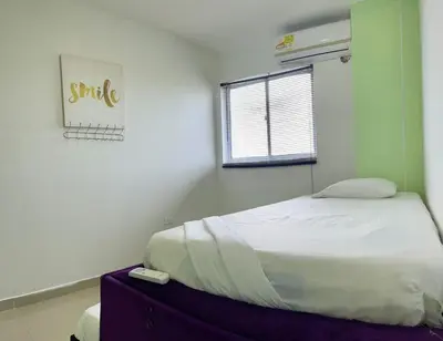 a bedroom with a bed with a remote control on it at Apartamento 405 in Cartagena de Indias