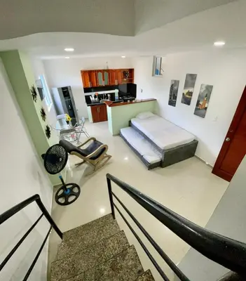 a large room with a bed and a staircase at Apartamento 403 in Cartagena de Indias