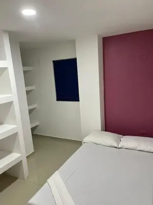a bedroom with a bed and a purple wall at Apartamento 201 in Cartagena de Indias