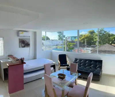 a bedroom with a bed and a couch and a table at Apartamento 201 in Cartagena de Indias