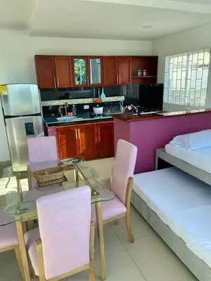 a kitchen with a table and chairs and a bed at Apartamento 201 in Cartagena de Indias