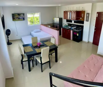 a living room with a dining table and a kitchen at Apartamento 408 in Cartagena de Indias