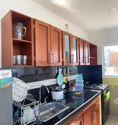 a kitchen with a sink and a stove and cabinets at Apartamento 301 in Cartagena de Indias