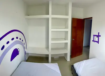 a bedroom with a bed and a book shelf at Apartamento 204 in Cartagena de Indias