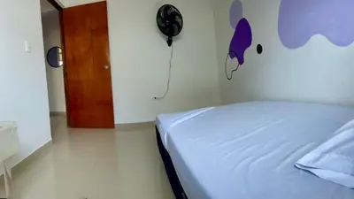 a bedroom with a bed and a clock on the wall at Apartamento 204 in Cartagena de Indias