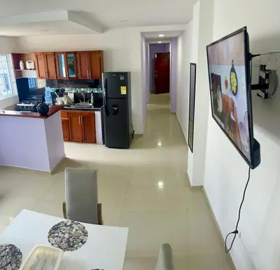 a kitchen with a table and a refrigerator at Apartamento 204 in Cartagena de Indias