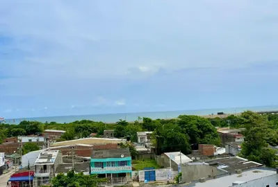 a city with houses and the ocean in the background at Apartamento 401 in Cartagena de Indias