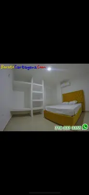 a small room with a bed and a desk at Apartamento 303 in Cartagena de Indias