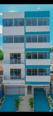 a tall building with a swimming pool in front of it at Apartamento 303 in Cartagena de Indias