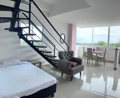 a bedroom with a staircase and a chair and a bed at Apartamento 402 in Cartagena de Indias