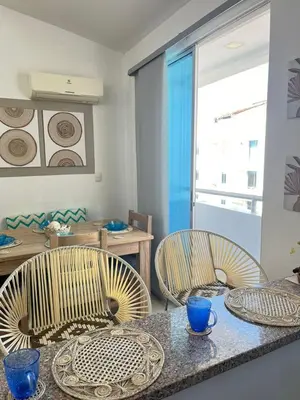 a dining room with two chairs and a table at Coveñas Apartamento vacacional caribe campestre 9-502 in Coveñas