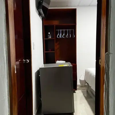 a room with a small refrigerator in a room at Habitación confortable y terraza Hamacas Coveñas in Coveñas