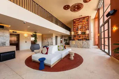 a living room with a white couch and a fireplace at Osh Hotel Cartagena in Cartagena de Indias