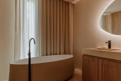 a bathroom with a bath tub and a sink at Osh Hotel Cartagena in Cartagena de Indias