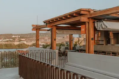 a building with a fence and tables and chairs at Osh Hotel Cartagena in Cartagena de Indias