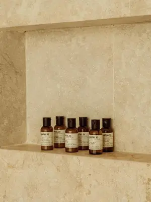 a row of four bottles of whiskey sitting on a shelf at Osh Hotel Cartagena in Cartagena de Indias