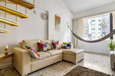 a living room with a couch and a hammock at Apartamento cerca al Mar in Cartagena de Indias