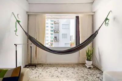 a hammock in a living room with a window at Apartamento cerca al Mar in Cartagena de Indias