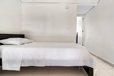 a white bedroom with a white bed in a room at Apartamento cerca al Mar in Cartagena de Indias