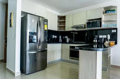 a kitchen with a stainless steel refrigerator and appliances at Apartamento en Bocagrande Cartagena in Cartagena de Indias