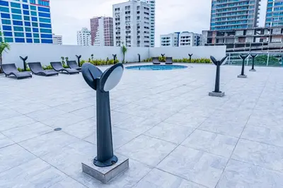 a courtyard with chairs and a pool in a city at Apartamento en Bocagrande Cartagena in Cartagena de Indias