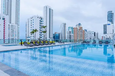 a large swimming pool in a city with tall buildings at Apartamento en Bocagrande Cartagena in Cartagena de Indias