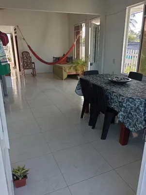 a dining room with a table and chairs at Sol y Mar in Isla Fuerte