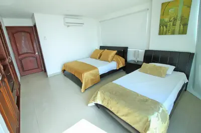 a room with two beds in a hotel room at Apartamento torres del lago in Cartagena de Indias