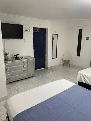 a bedroom with a bed and a dresser and a tv at Habitación cerca al aeropuerto 1 in Cartagena de Indias