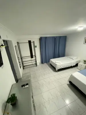 a hotel room with two beds and a window at Habitación cerca al aeropuerto 1 in Cartagena de Indias