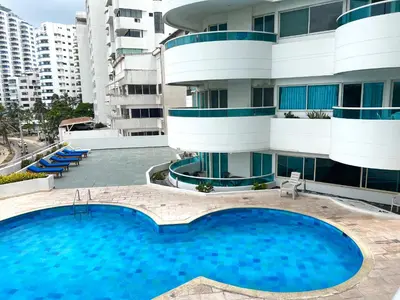 a large swimming pool in front of a building at torres del lago apartamento in Cartagena de Indias