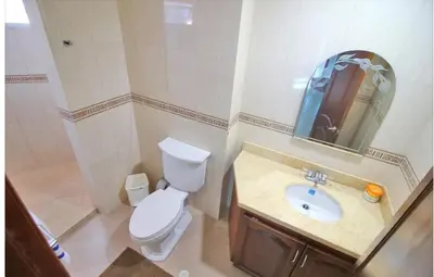 a bathroom with a toilet and a sink and a mirror at torres del lago apartamento in Cartagena de Indias