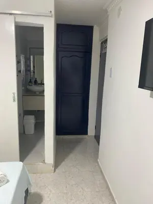 a bathroom with a blue door and a sink at Habitación cerca al aeropuerto 3 in Cartagena de Indias