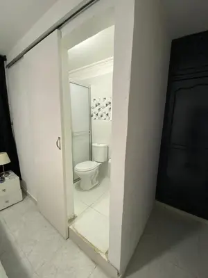 a white bathroom with a toilet in a room at Habitación cerca al aeropuerto 3 in Cartagena de Indias