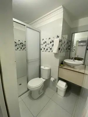 a white bathroom with a toilet and a sink at Habitación cerca al aeropuerto 3 in Cartagena de Indias