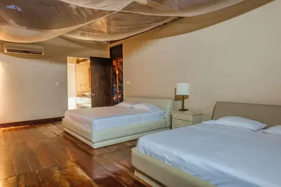 a bedroom with two beds and a ceiling at Castillete Hotel & Beach Club in Tierra Bomba