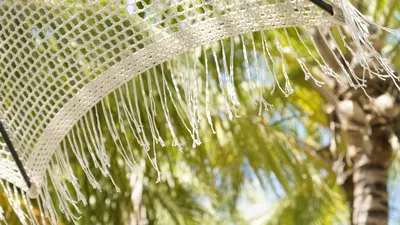 a net with water dripping from a palm tree at Castillete Hotel & Beach Club in Tierra Bomba