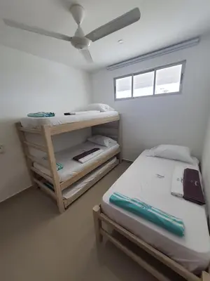 a bedroom with a bunk bed and a ceiling fan at Hermoso apartamento con piscina frente al mar - Primera Ensenada in Coveñas