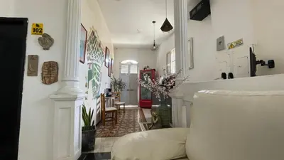 a living room with a couch and a hallway at HOSTEL M&H in Cartagena de Indias