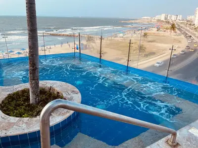 a view of the ocean from the balcony of a resort at Front beach apartment close to the Cartagena letters in Cartagena de Indias
