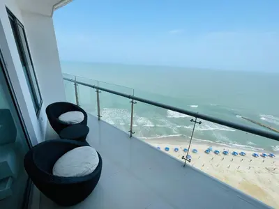 a balcony with a view of the beach at Front beach apartment close to the Cartagena letters in Cartagena de Indias