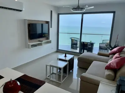 a living room with a couch and a tv at Front beach apartment close to the Cartagena letters in Cartagena de Indias