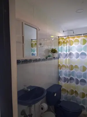 a bathroom with a blue toilet and a sink at Apartamento turistico Mariangel in Cartagena de Indias
