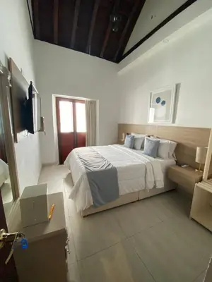 a bedroom with a bed and a television in it at Hotel Casa Agustina in Cartagena de Indias