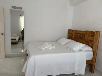 a bedroom with a bed with two towels on it at Apartaestudio en Tolú - Itze solaris in Tolú