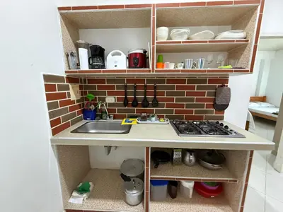 a kitchen with a sink and a brick wall at Apartaestudio en Tolú - Itze solaris in Tolú