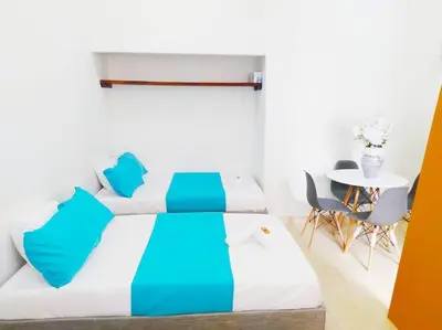 a bedroom with a bed and a table and chairs at Apartamento centro histórico 303-2 in Cartagena de Indias