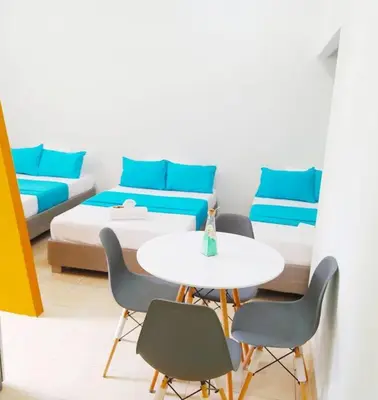 a room with a bed and a table and chairs at Apartamento centro histórico 303-2 in Cartagena de Indias