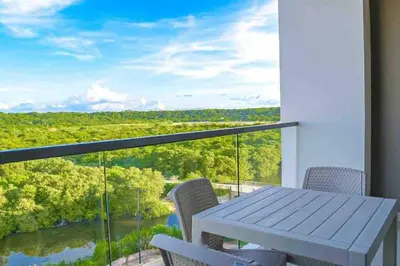 a table and chairs on a balcony with a view at Fantastic Loft/Beachfront+Pools in Cartagena de Indias